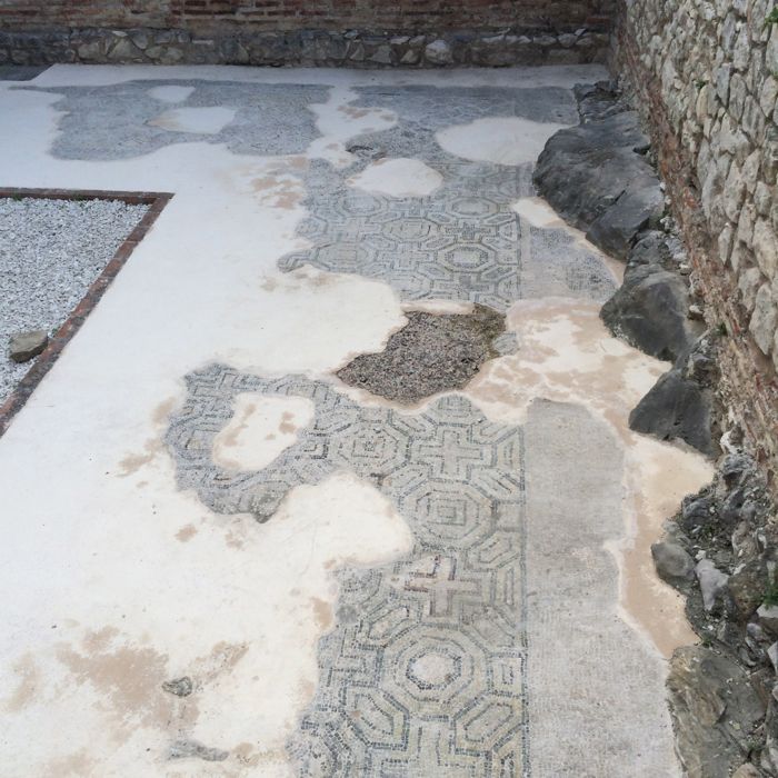 Split mosaics in sidewalk